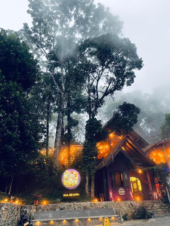 a sign in front of a house with lights at Ever After - Ella, Sri Lanka in Ella
