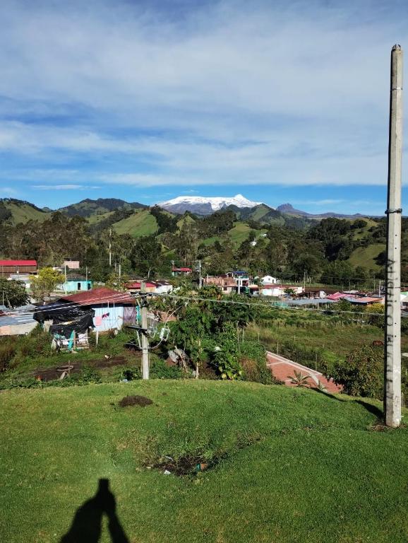 a shadow of a person taking a picture of a city at Los frailejones in Murillo