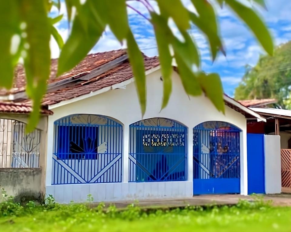 a house with blue gates and green grass at Casa em Soure in Soure