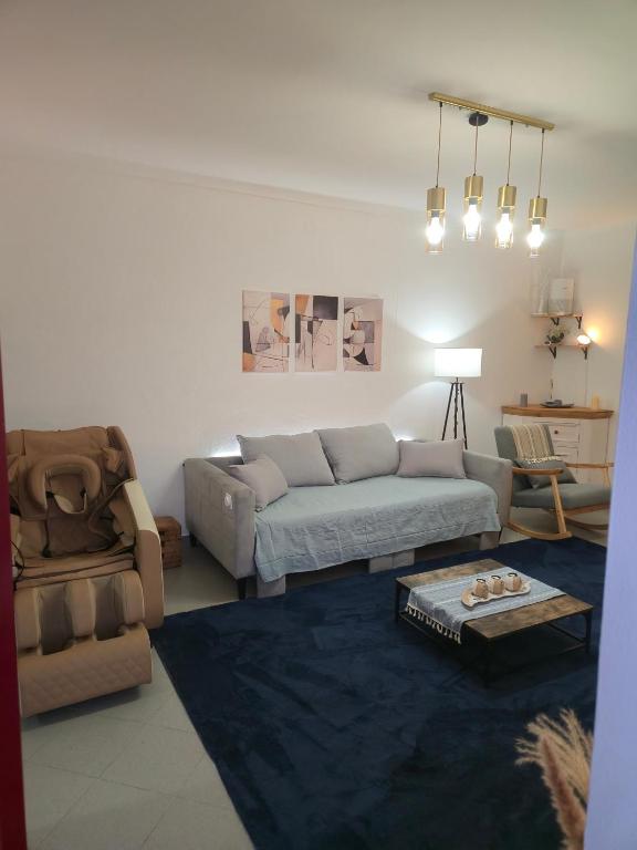 a living room with a couch and a chair at Monte do Moinho Vento in Casas Novas de Marés