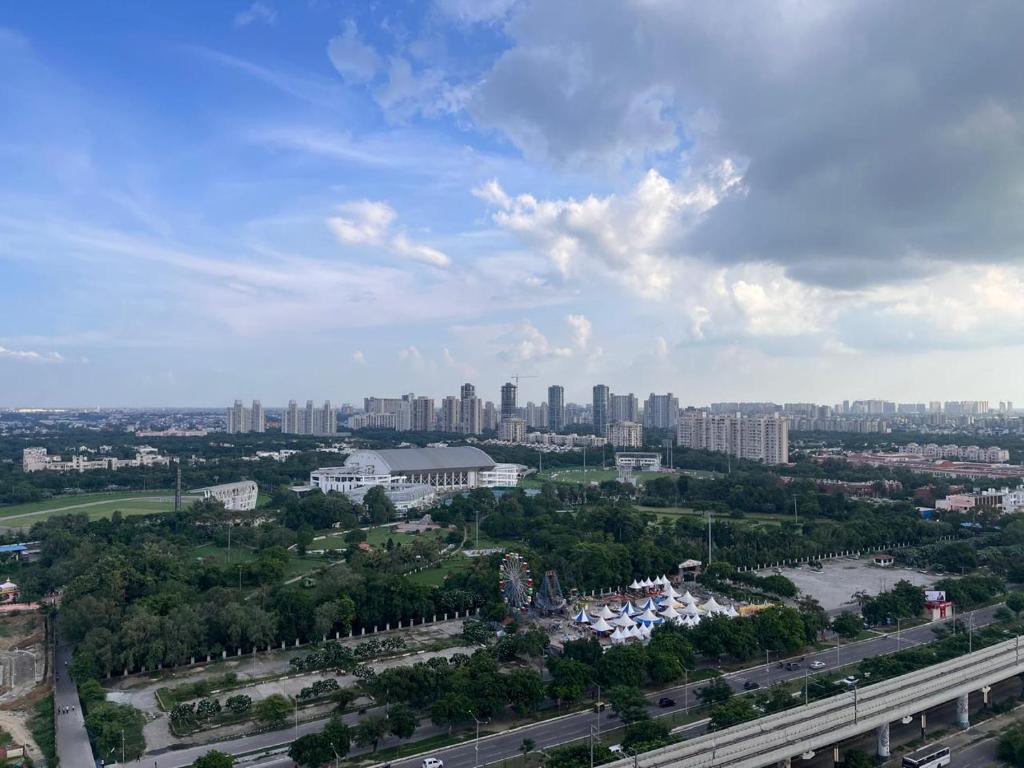 an aerial view of a city with tall buildings at Serene View Apartment in Greater Noida
