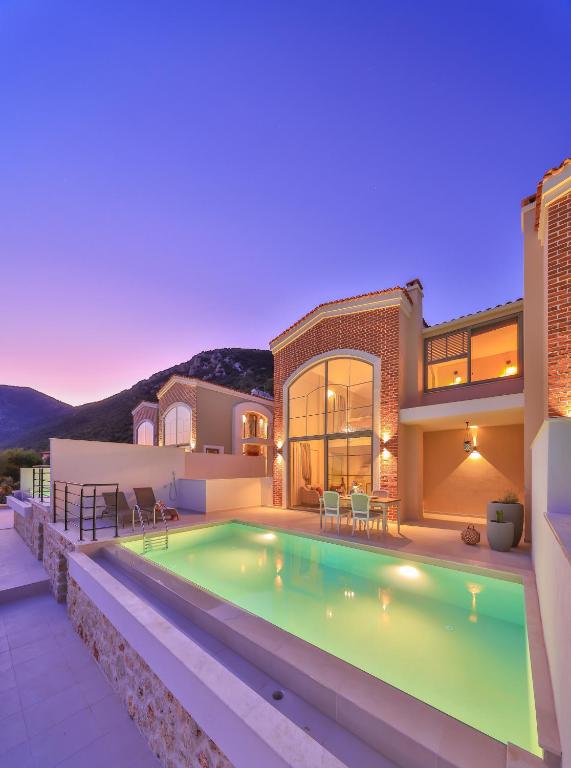 a house with a swimming pool in front of a house at Terranova Villas in Cukurbag