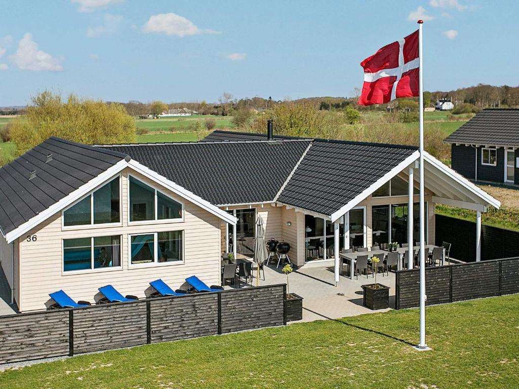 a house with a flag on top of it at Luxury Pool Retreat by Sea - By Traum Ferienwohnungen in Bogense