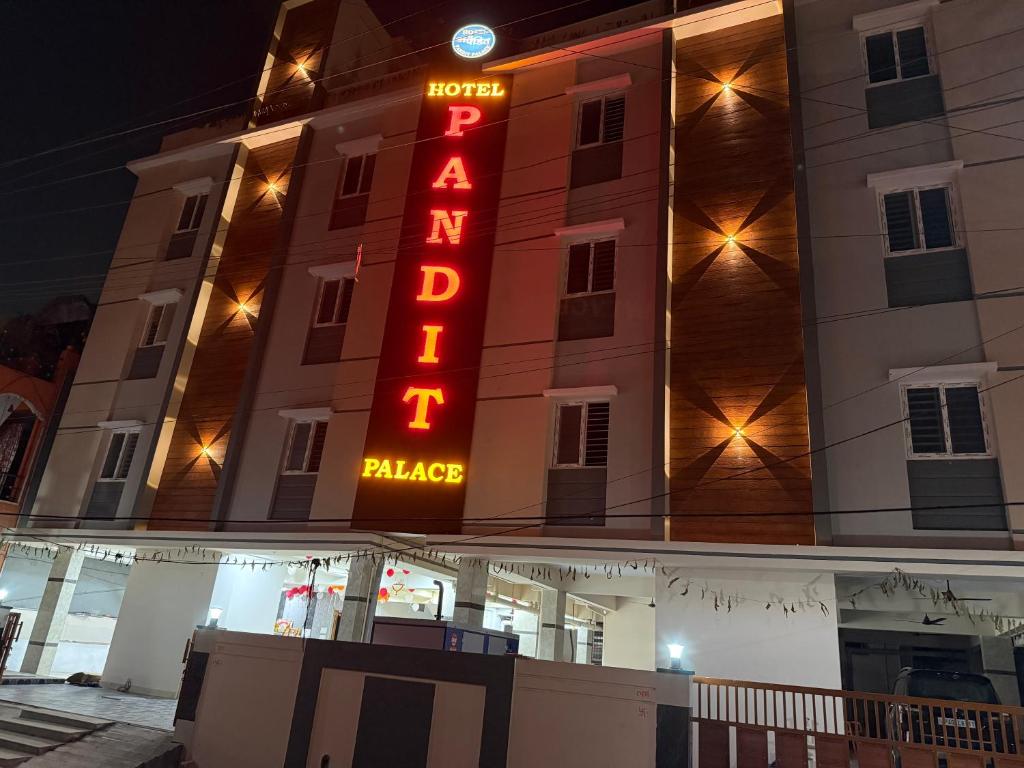 a hotel sign on the side of a building at Hotel PANDIT PALACE in Visakhapatnam