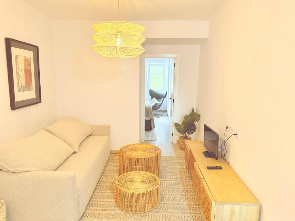 a living room with a couch and a table at Ola A Coruña in A Coruña