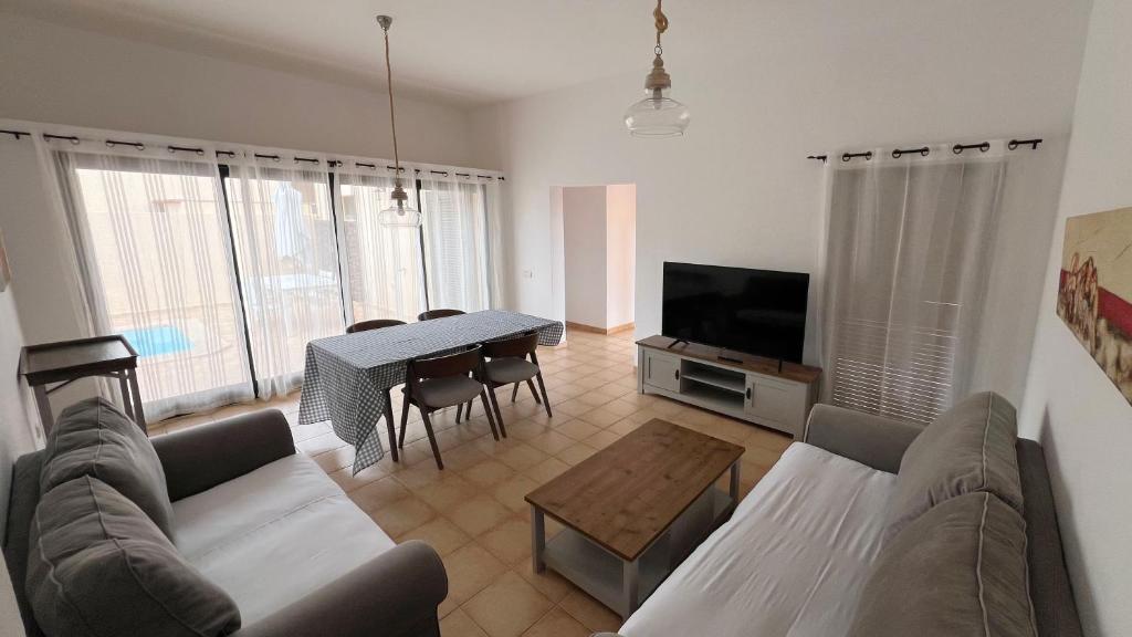 a living room with a couch and a table at Anahi Homes Corralejo- Dracaena 18 in La Oliva