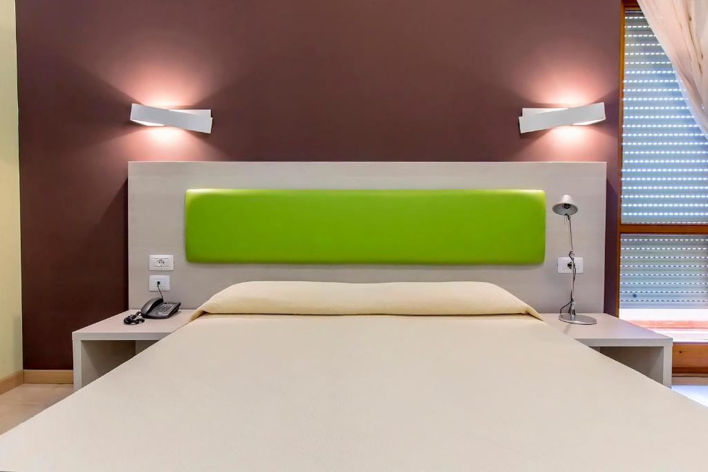A bed or beds in a room at Hotel Residence Ulivi E Palme