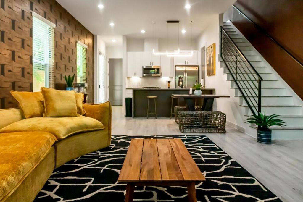 a living room with a couch and a table at Spacious 3BR Retreat Pergola and Fire Pit in Houston