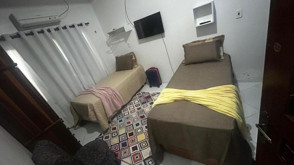 Ένα ή περισσότερα κρεβάτια σε δωμάτιο στο Casa de temporada
