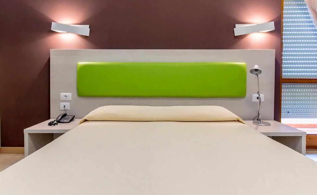 A bed or beds in a room at Hotel Residence Ulivi E Palme