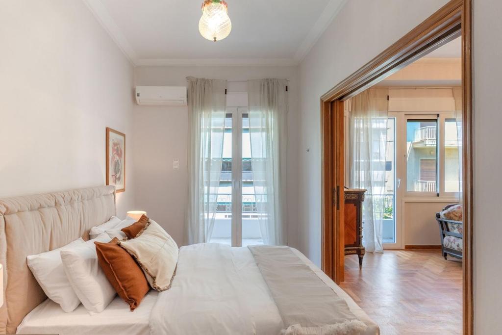 a bedroom with a large white bed and a mirror at Athenian Manor by Staycom in Athens