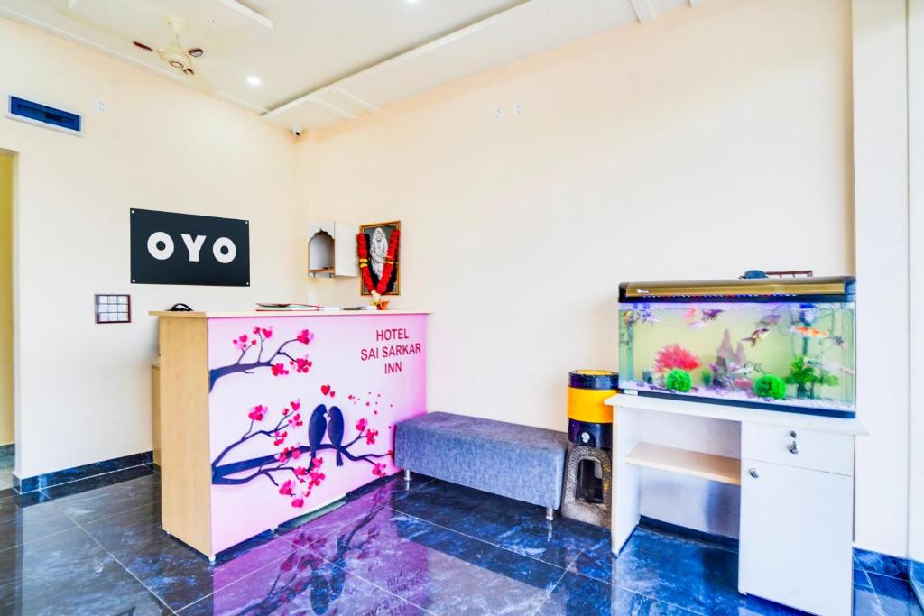 a room with a fish tank and a bench at Hotel O Sai Sarkar Inn in Rāipur