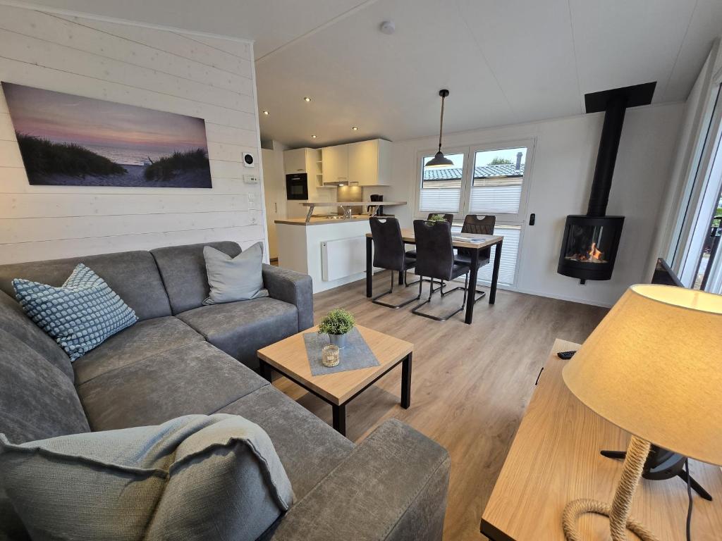 a living room with a couch and a table at Ostseeferienpark Walkyrien - Lotse h in Kagelbusch
