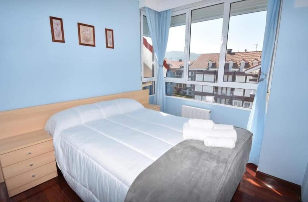 En eller flere senge i et værelse på Apartamento Luris