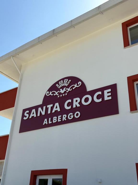 a sign on the side of a santa cruz alberoco gas station at Albergo Santa Croce in Giffoni Sei Casali