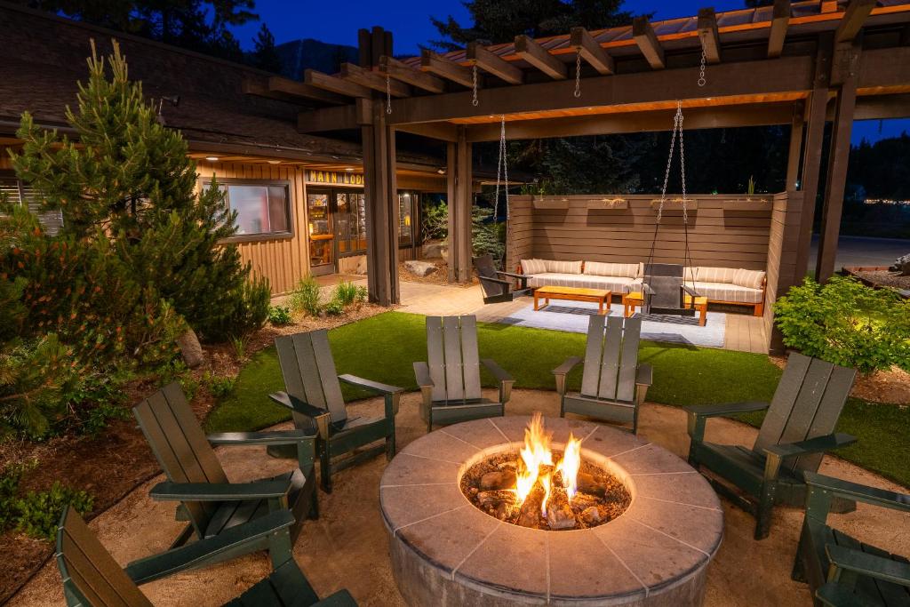 a fire pit in a yard with chairs and a patio at Station House Inn South Lake Tahoe in South Lake Tahoe