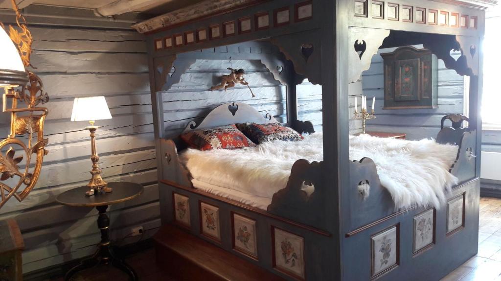 a bedroom with a bed in a wooden room at Lysko Gjestegård in Larvik