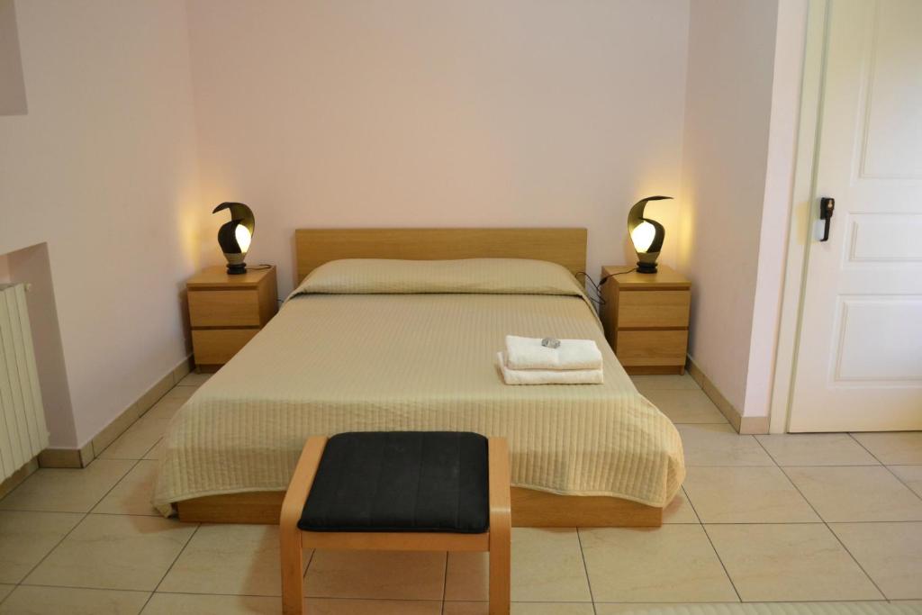 a bedroom with a bed with a chair and two lamps at Hotel Acquaplanet in Paterno