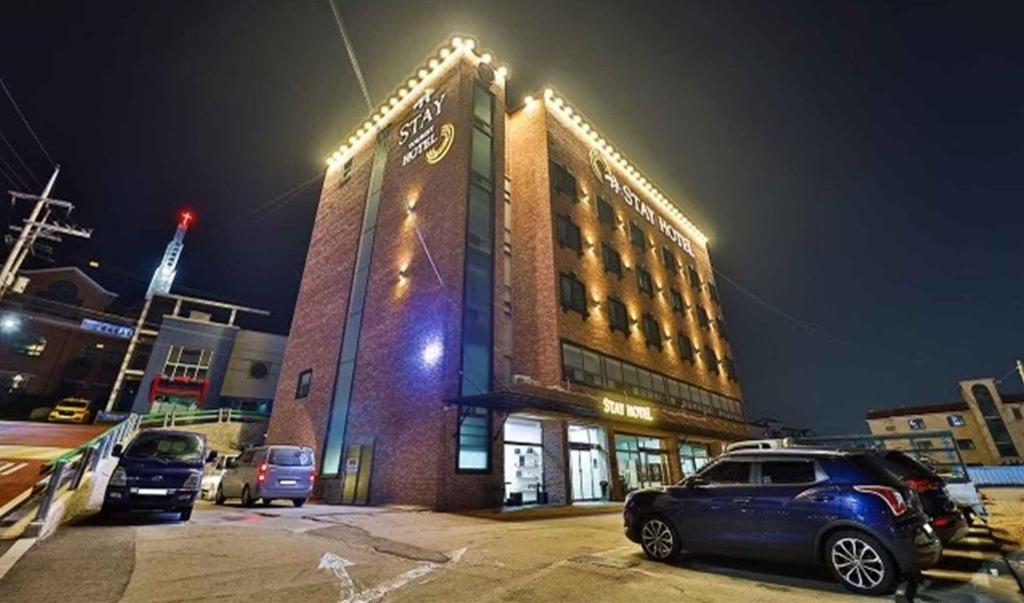 a building with a car parked in a parking lot at Yeongjong Stay Hotel in Incheon