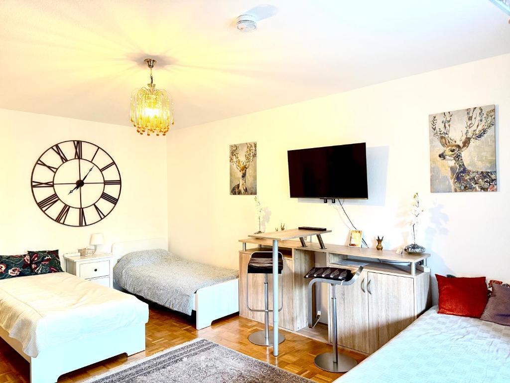 a living room with a bed and a desk at Welcome to Messe! Two-bedroom SmartApartment &Balcony in Hannover