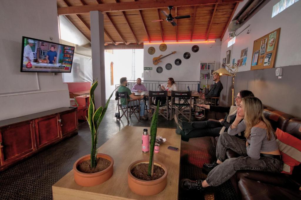a group of people sitting in a room watching tv at Play Hostel Soho in Buenos Aires