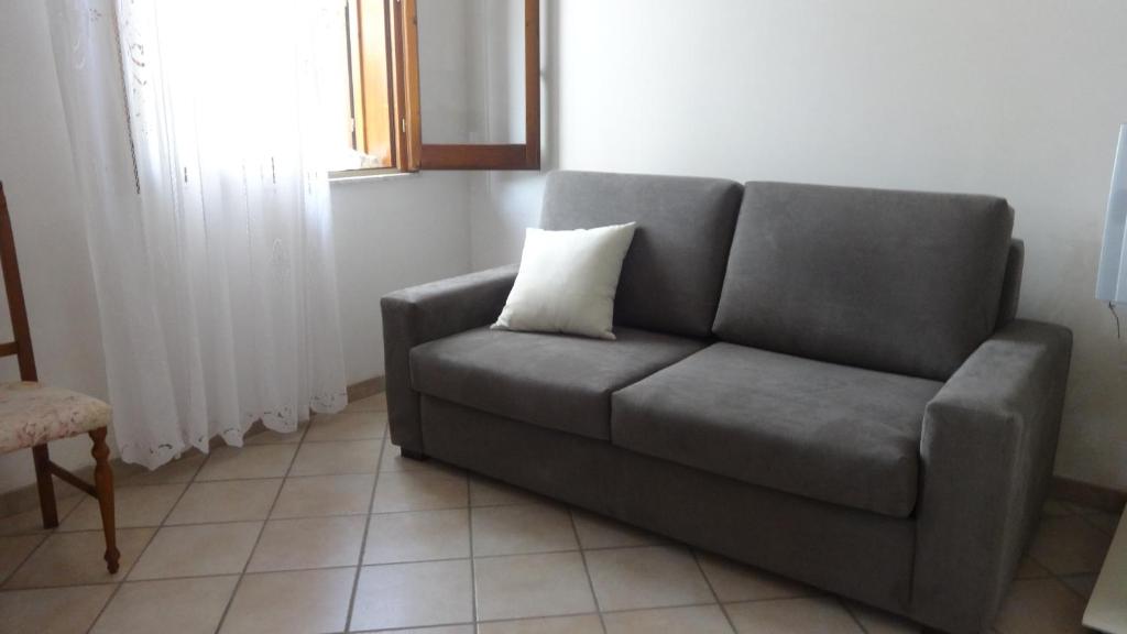 a couch in a living room with a pillow on it at Le Ciaramire in Favignana