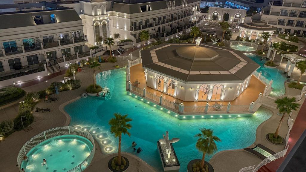an overhead view of a large swimming pool in a building at Dubai Luxury 1BR Apartment Lagoon View Near Miracle Garden Pool Spa by Green Sky Holiday Homes in Dubai
