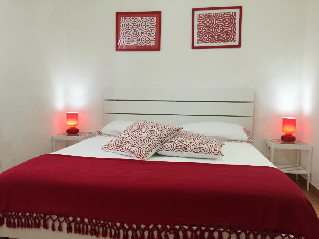 a bedroom with a large bed with two lamps at Villa Cenzina in Marina di Pisticci