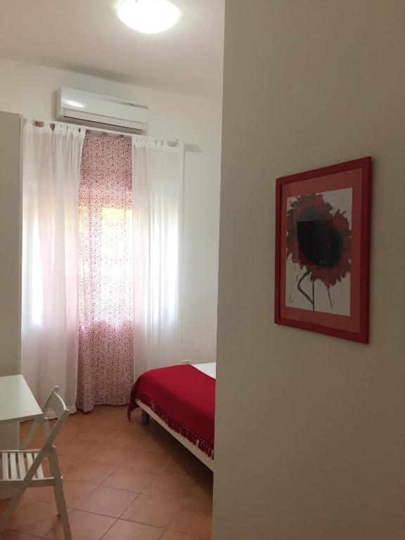 a bedroom with a bed and a window at Villa Cenzina in Marina di Pisticci
