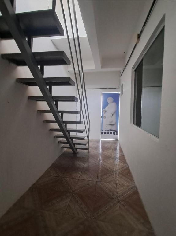 a staircase in a room with a painting on the wall at Central in Juazeiro do Norte