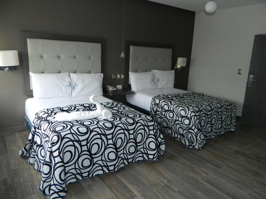 Postel nebo postele na pokoji v ubytování Hotel Flamingo Merida