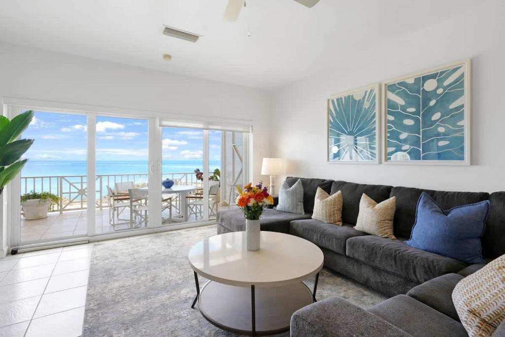 a living room with a couch and a table at Coconut Bay Villas #122 in George Town