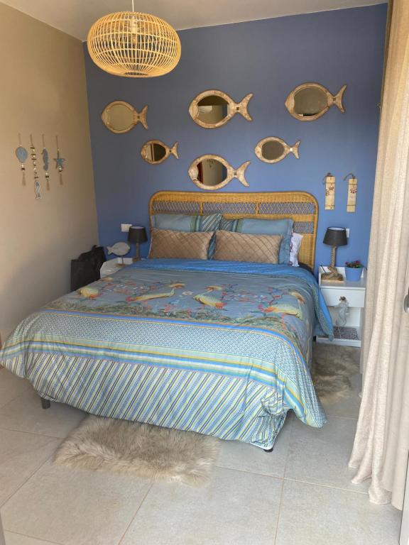 a bedroom with a bed with fish plates on the wall at Guesthouse il Mare in San Vito dei Normanni