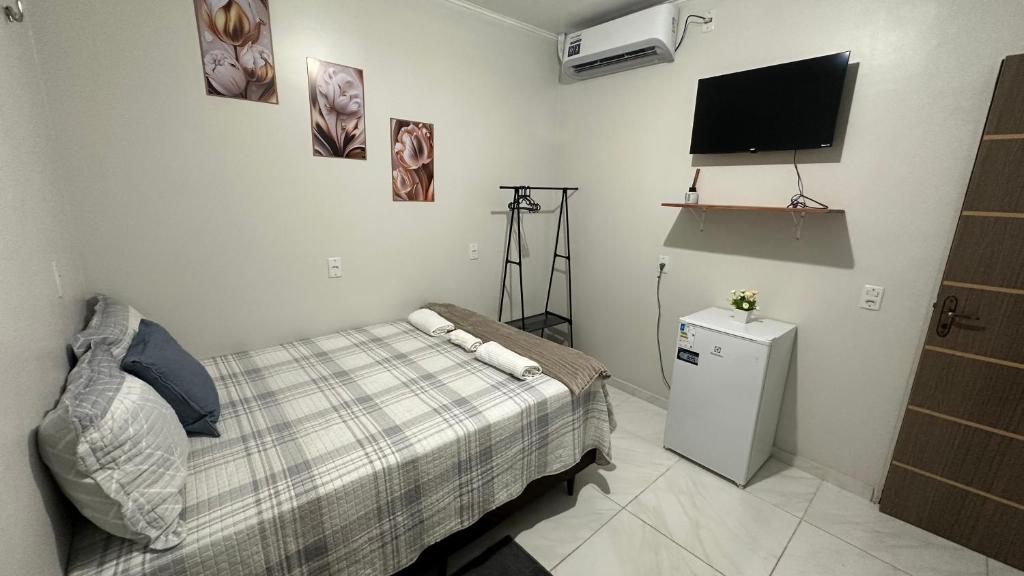 Ένα ή περισσότερα κρεβάτια σε δωμάτιο στο Aconchego Hospedagem