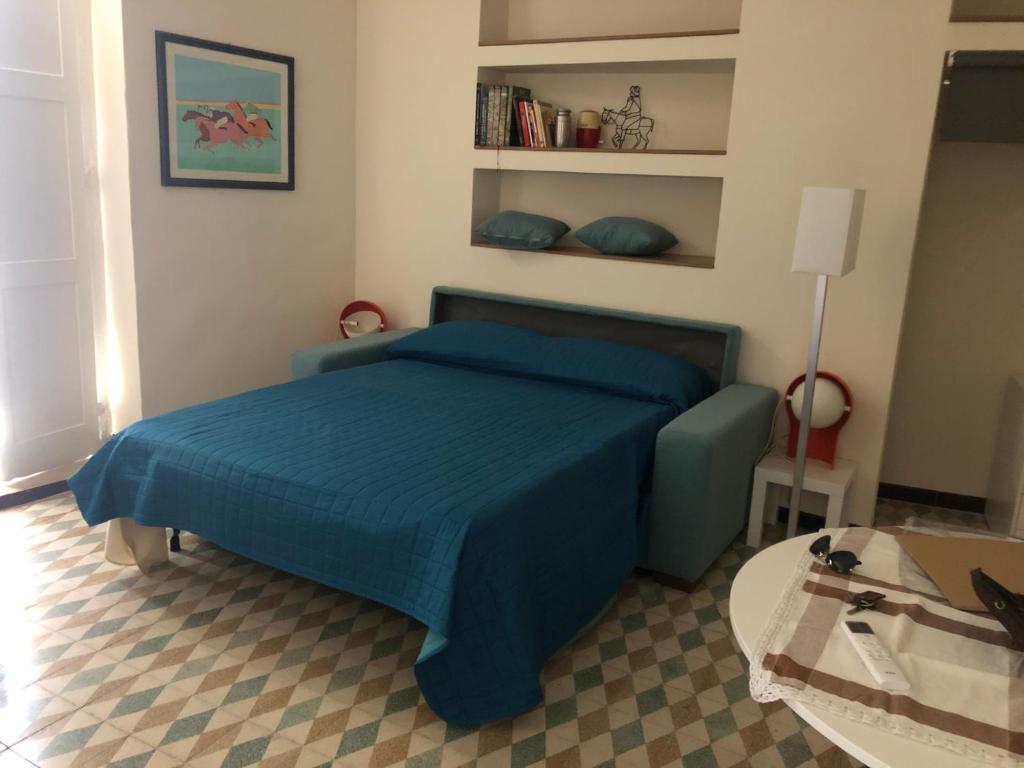 a bedroom with a blue bed and a table at Il fiore Blue in Barletta
