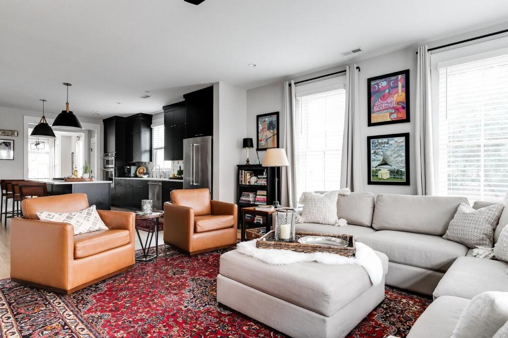 a living room with couches and chairs and a kitchen at Bright and Modern 3BR - Walk to Dining and Park in Richmond