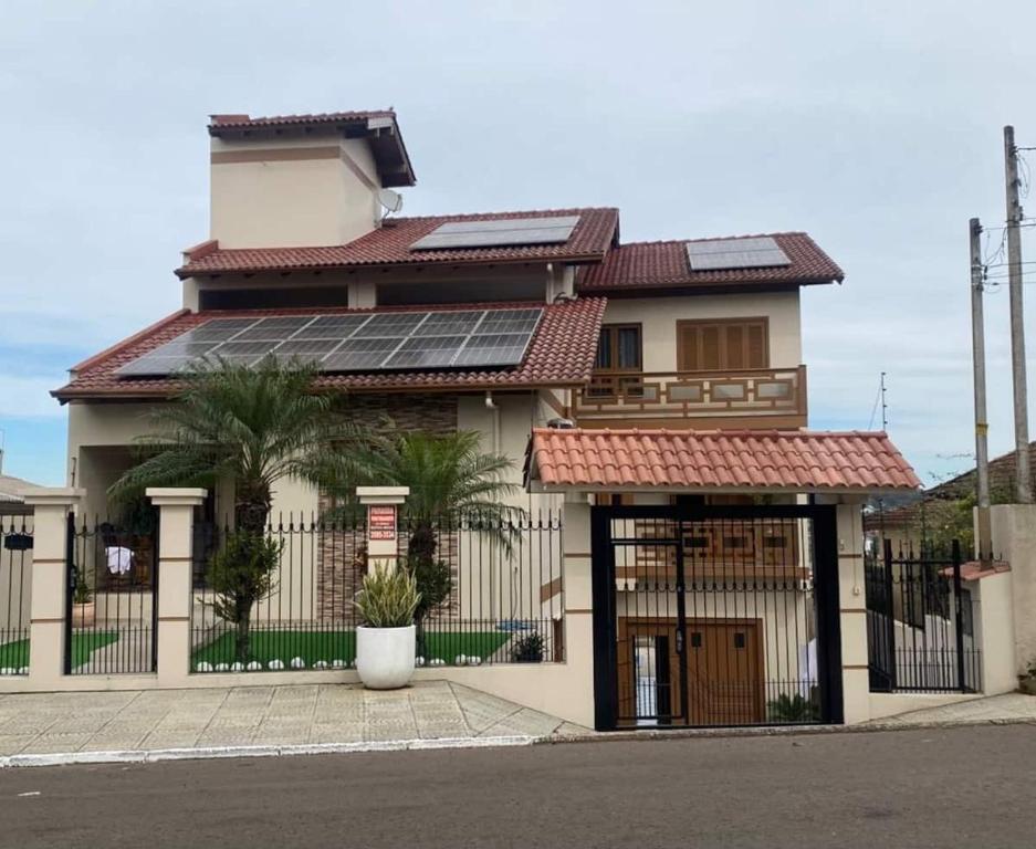 a house with solar panels on top of it at Apartamento 2 quartos Completo in Novo Hamburgo