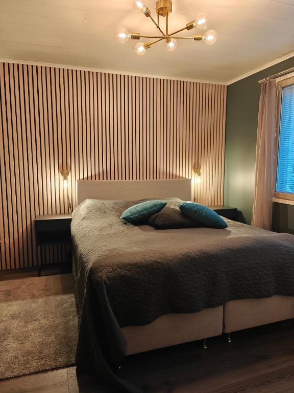 a bedroom with a bed and a ceiling fan at Villa Pare in Rovaniemi