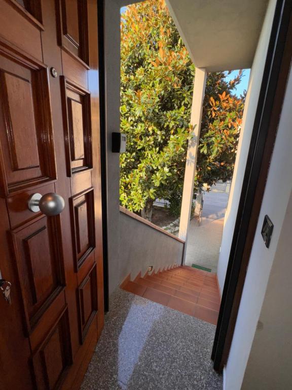 an open door with a view of a tree at Sweet charm in Venice in Tessera