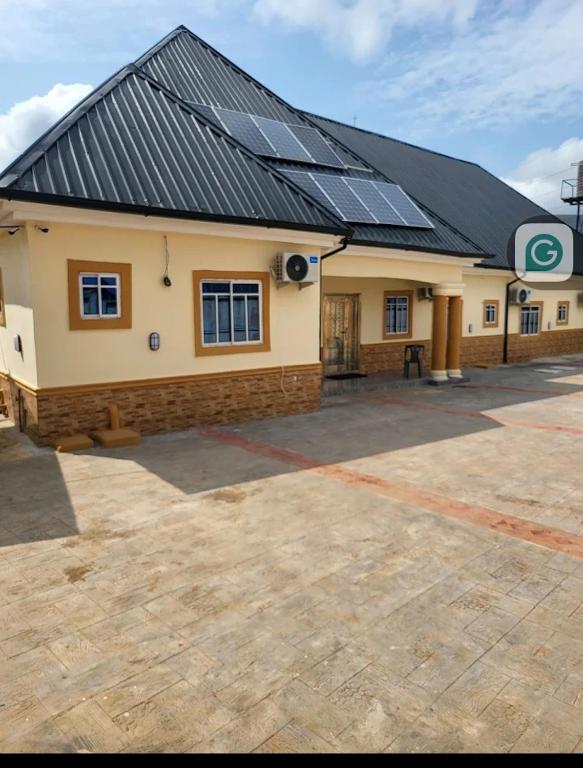 a building with solar panels on top of it at Ohio city hotel in Owerri