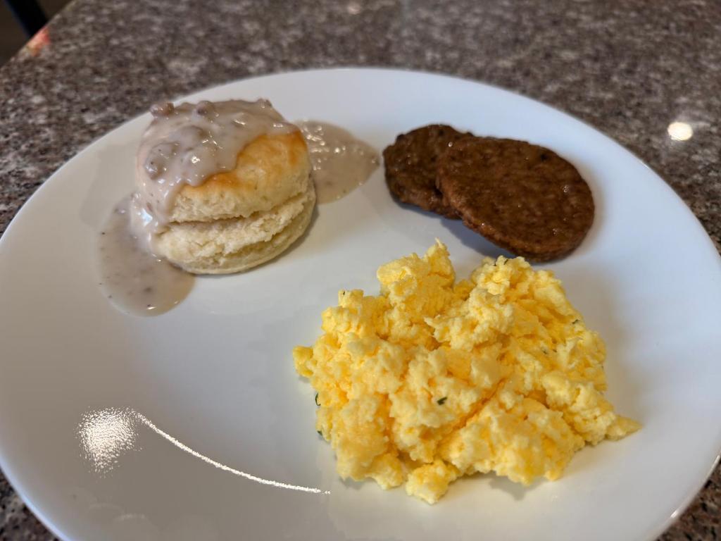 a white plate with breakfast foods on a table at Quality Inn I-75 West Chester-North Cincinnati in West Chester
