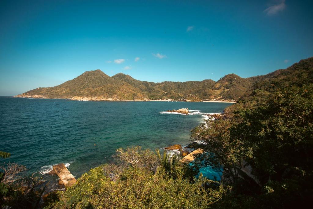 a view of a beach with mountains in the background at Corrales Bay Resort in Corrales