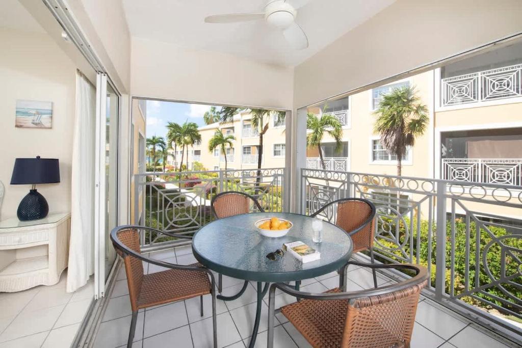 a patio with a table and chairs on a balcony at Regal Beach Club #322 in George Town