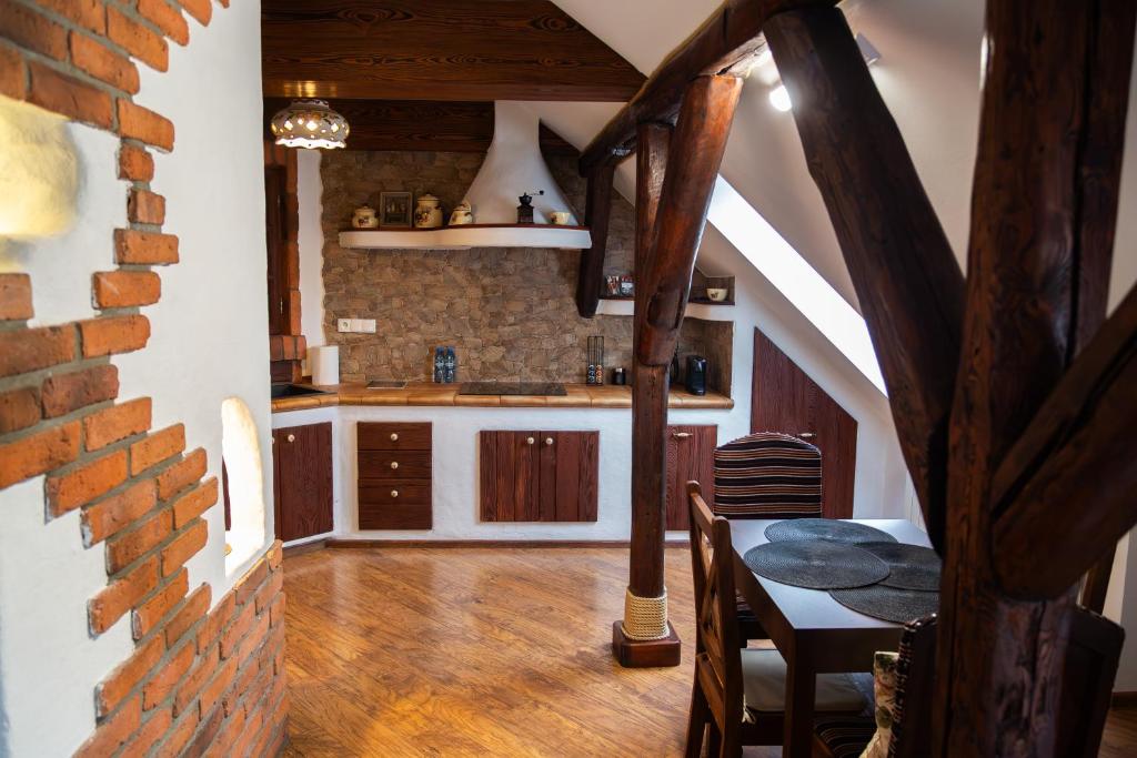 a kitchen with a table and a dining room at Apartament Rustykalny in Ostrowiec Świętokrzyski