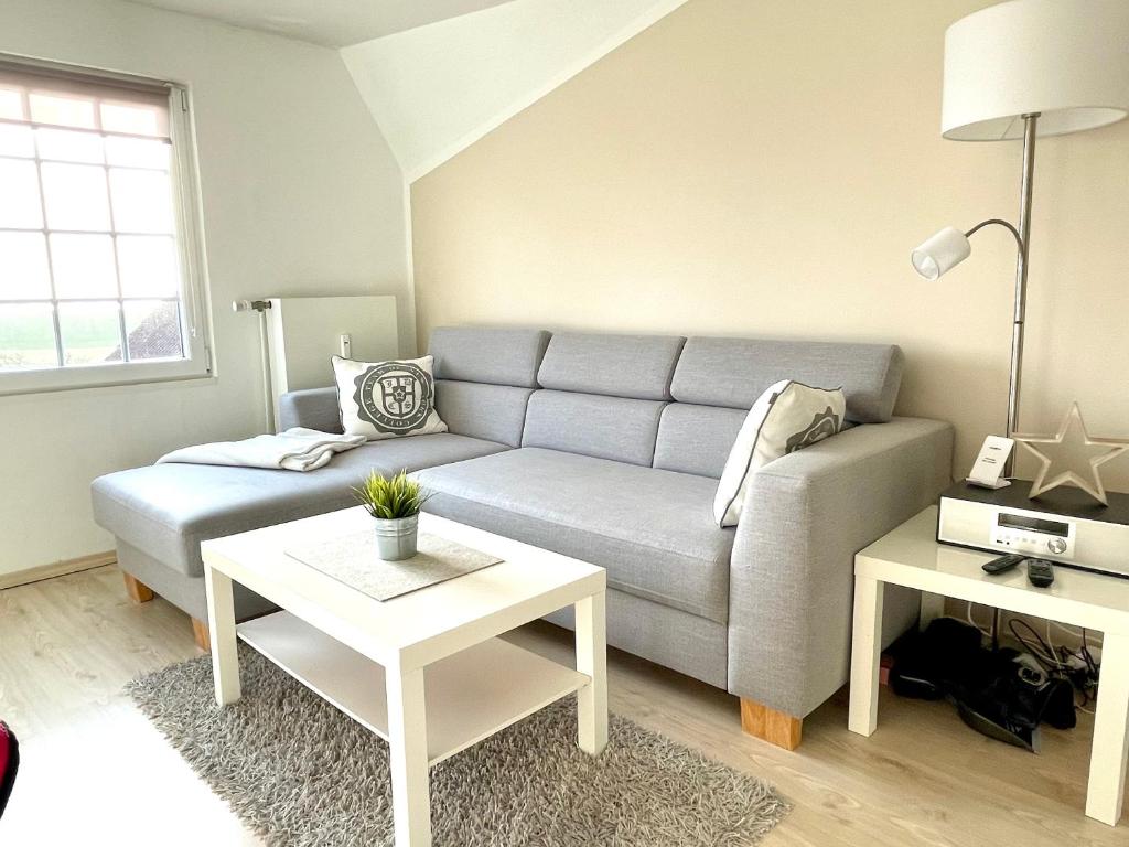 a living room with a couch and a table at Leuchtturm in Juist
