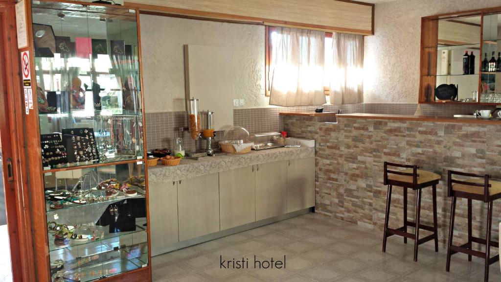 a kitchen with a counter and some chairs in it at Kristi in Póros Kefalonias