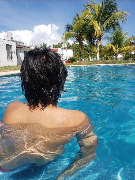 a person is sitting in a swimming pool at Departamento en la Huertas in Barrio Nuevo