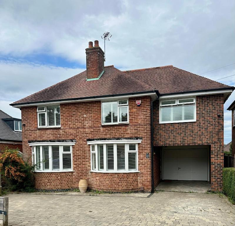 a red brick house with a garage at Amazing City Centre Home in Derby