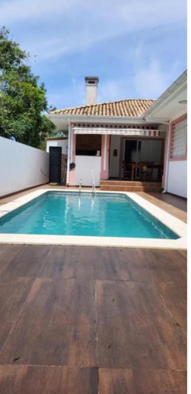 a swimming pool in the backyard of a house at Itacurubi Florianópolis in Florianópolis