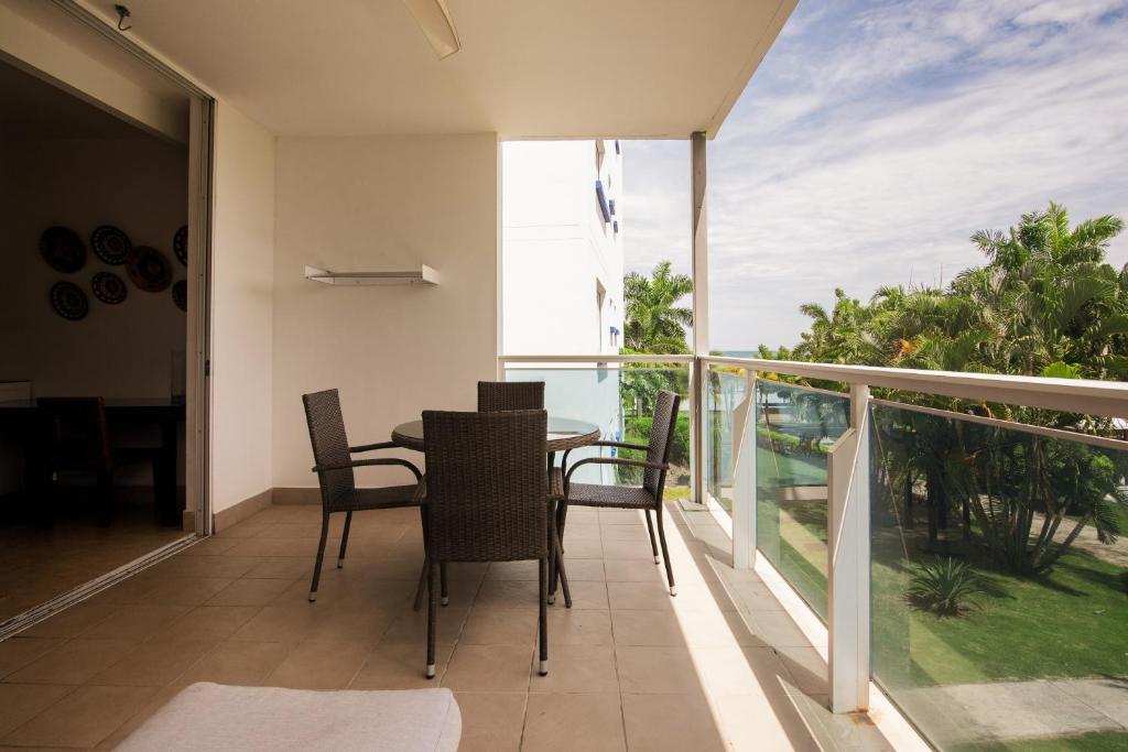 a balcony with a table and chairs on a balcony at Beach Apartment At Nikki Residences 2 Bedroom in El Chirú